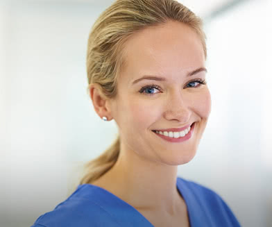 Smiling woman in hospital scrubs