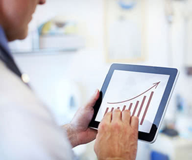 doctor looking at chart on tablet device